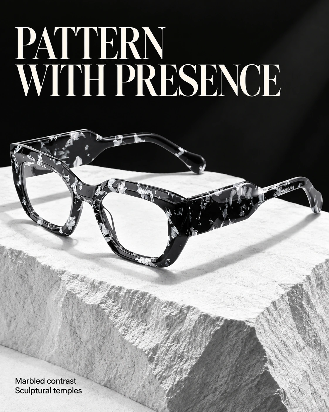 Black-and-white marbled acetate eyewear on a stone plinth — Pattern with Presence